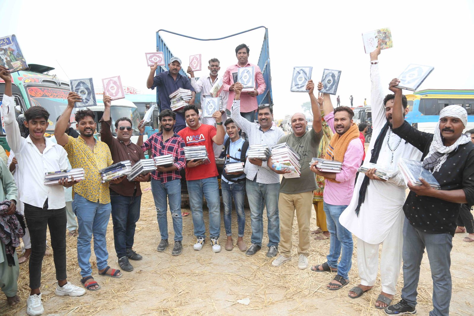 A group of believers in Pakistan holding up their free Urdu Bibles outdoors