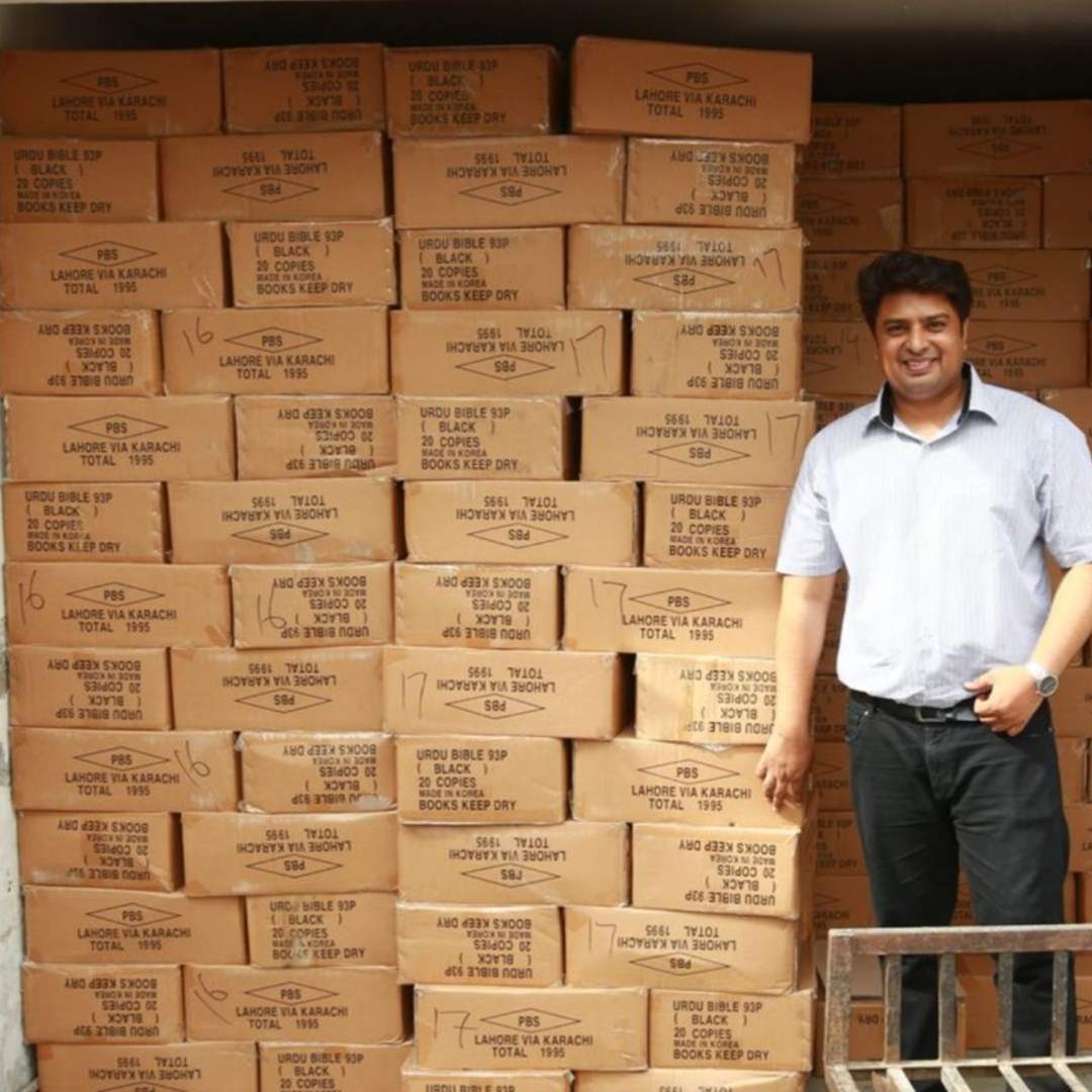 Rev. Dr. Naeem Nasir with boxes of Urdu Bibles: the goal is one million free Urdu Bibles by 2033