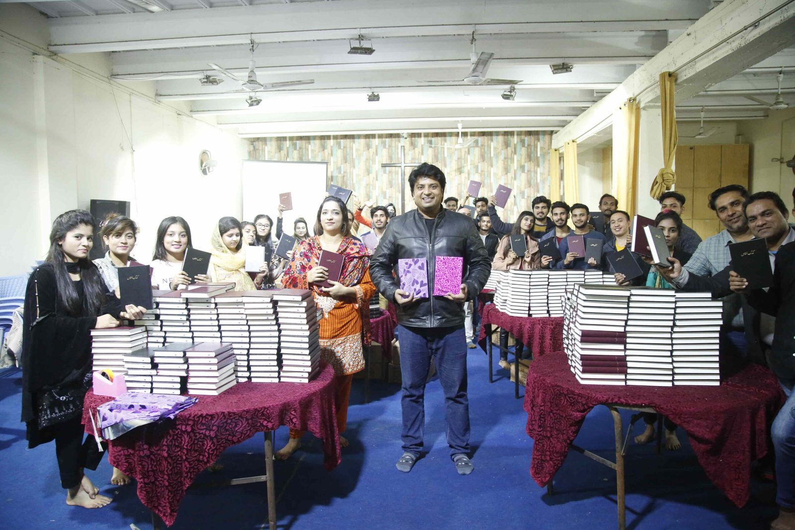 Students at Revelation Bible College in Pakistan with stacks of Urdu Bibles for their ministries