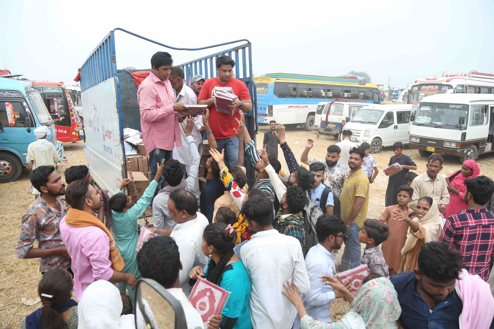 Urdu Bibles handed out from a truck to a crowd at a festival in Pakistan